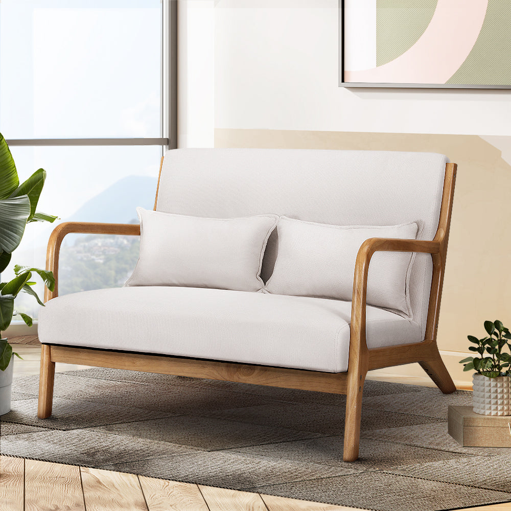 White sofa with wooden frame in a living room setting