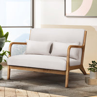 White sofa with wooden frame in a living room setting